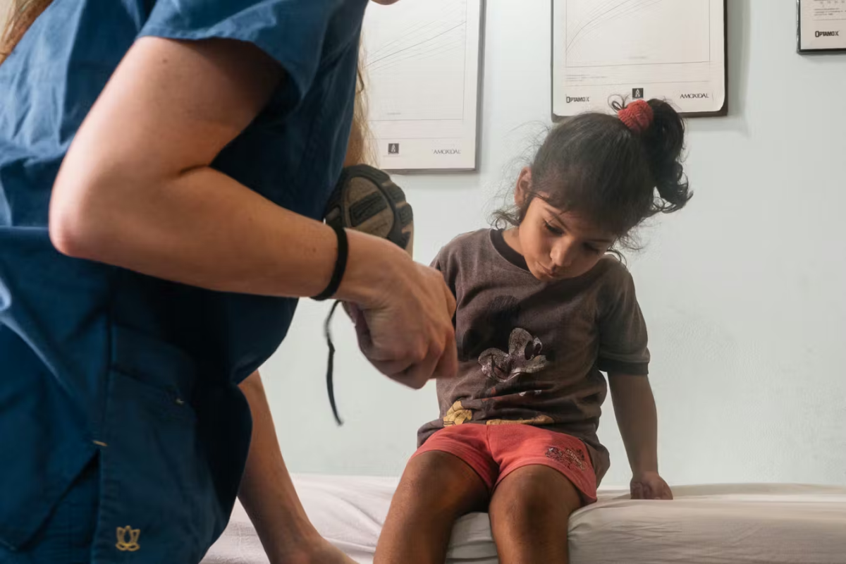 IVHQ Volunteer performing a checkup on a young child.
