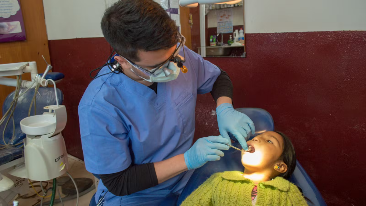 IVHQ Volunteer performing a Dental Checkup on a Child in Antigua Guatemala