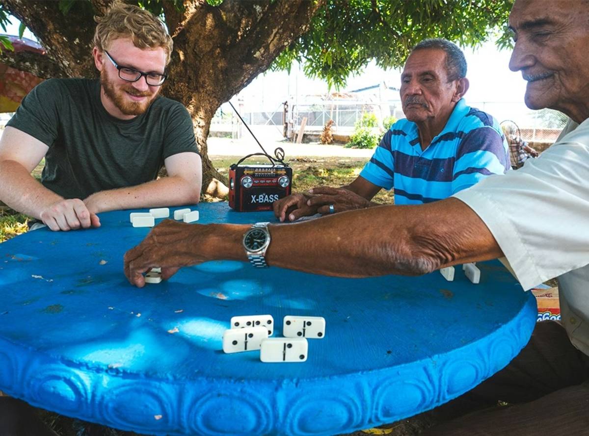 IVHQ Volunteer playing Dominoes with Senior Citizens in Guatemala
