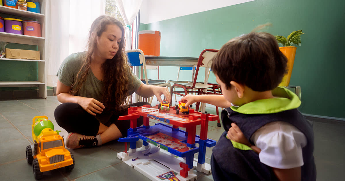 IVHQ Volunteer playing with trucks with a child in Argentina