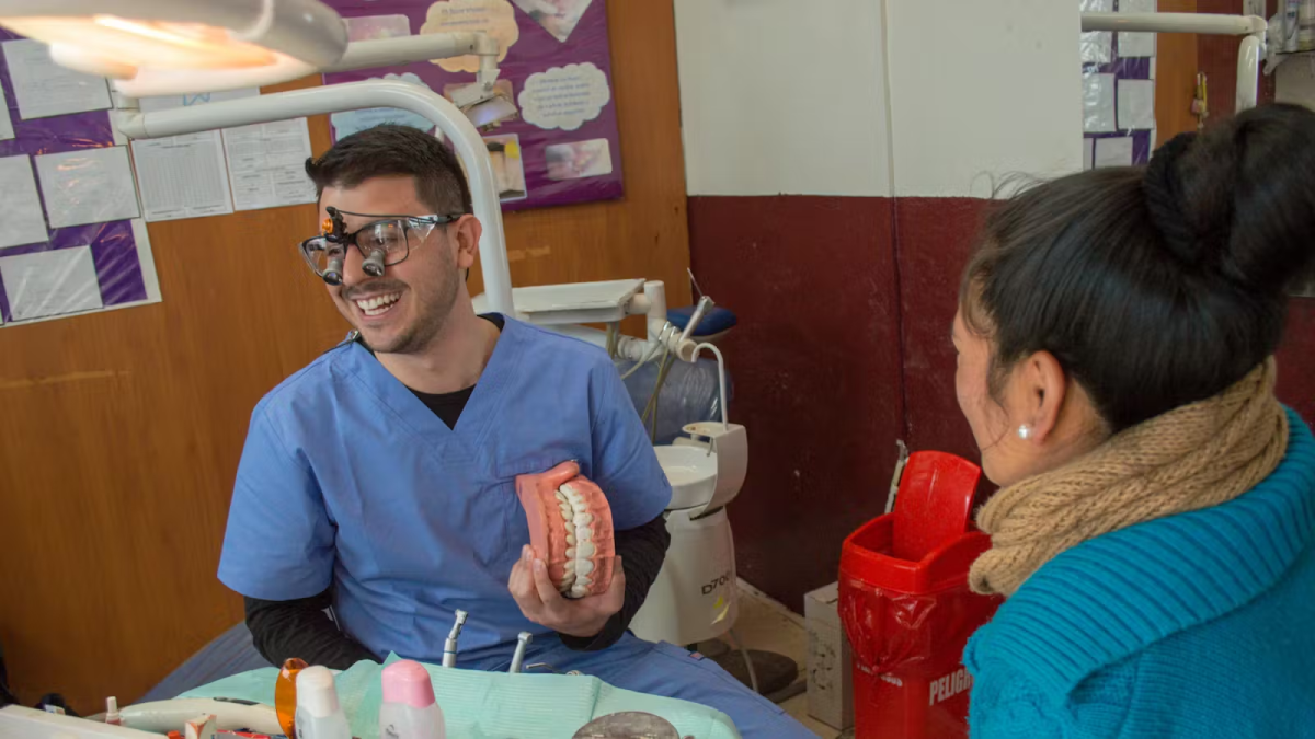 IVHQ Volunteers Holding fake teeth and performing Dental work