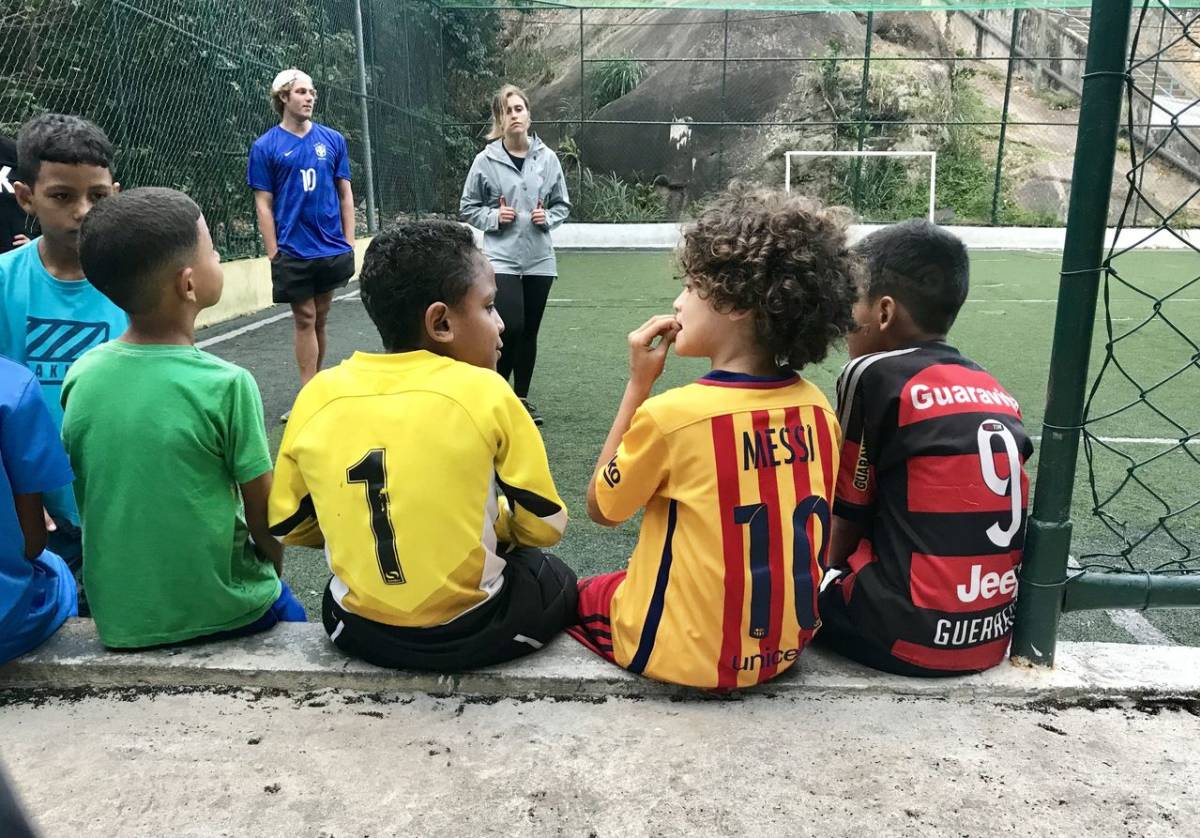 IVHQ Volunteers playing football with students in Brazil