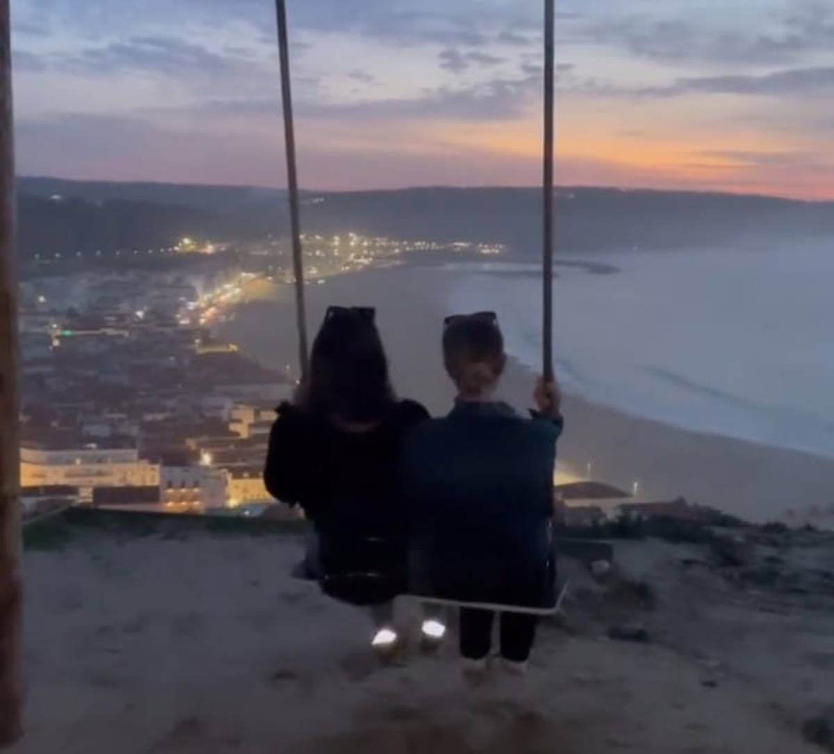 Lisbon at night with view two friends at cliff