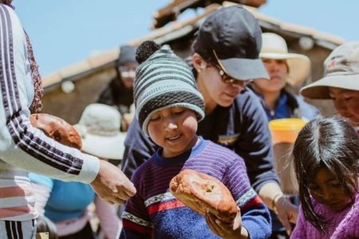 Little Peruvian boy holding bread