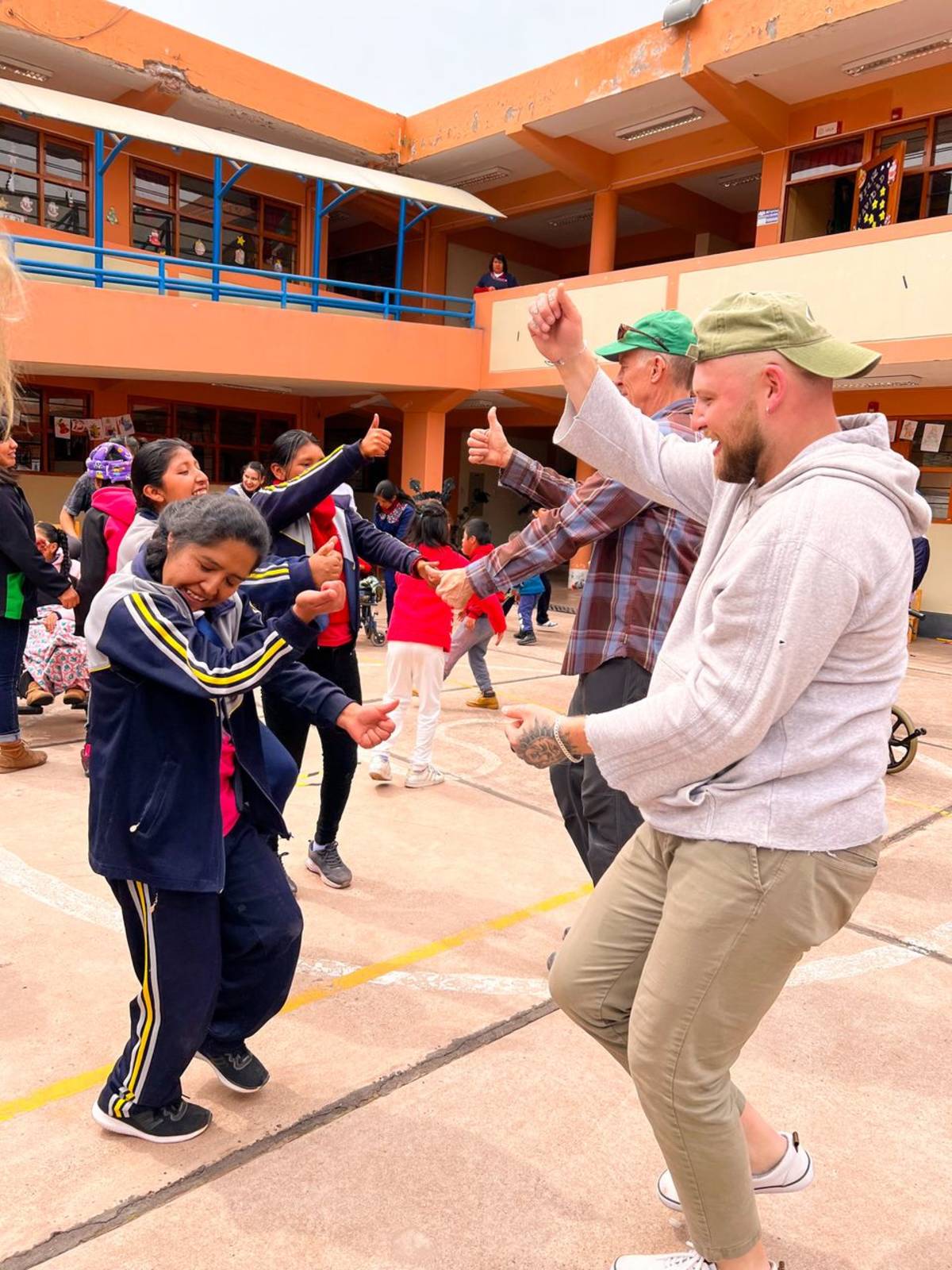 Male Volunteers Dancing with Local Children in Guatemala