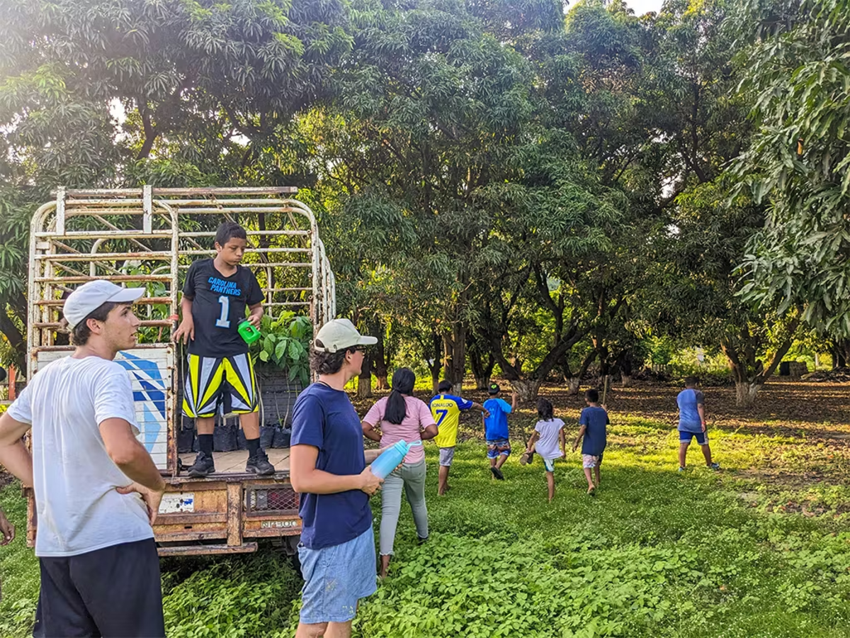 Male Volunteers taking Children Outside to play