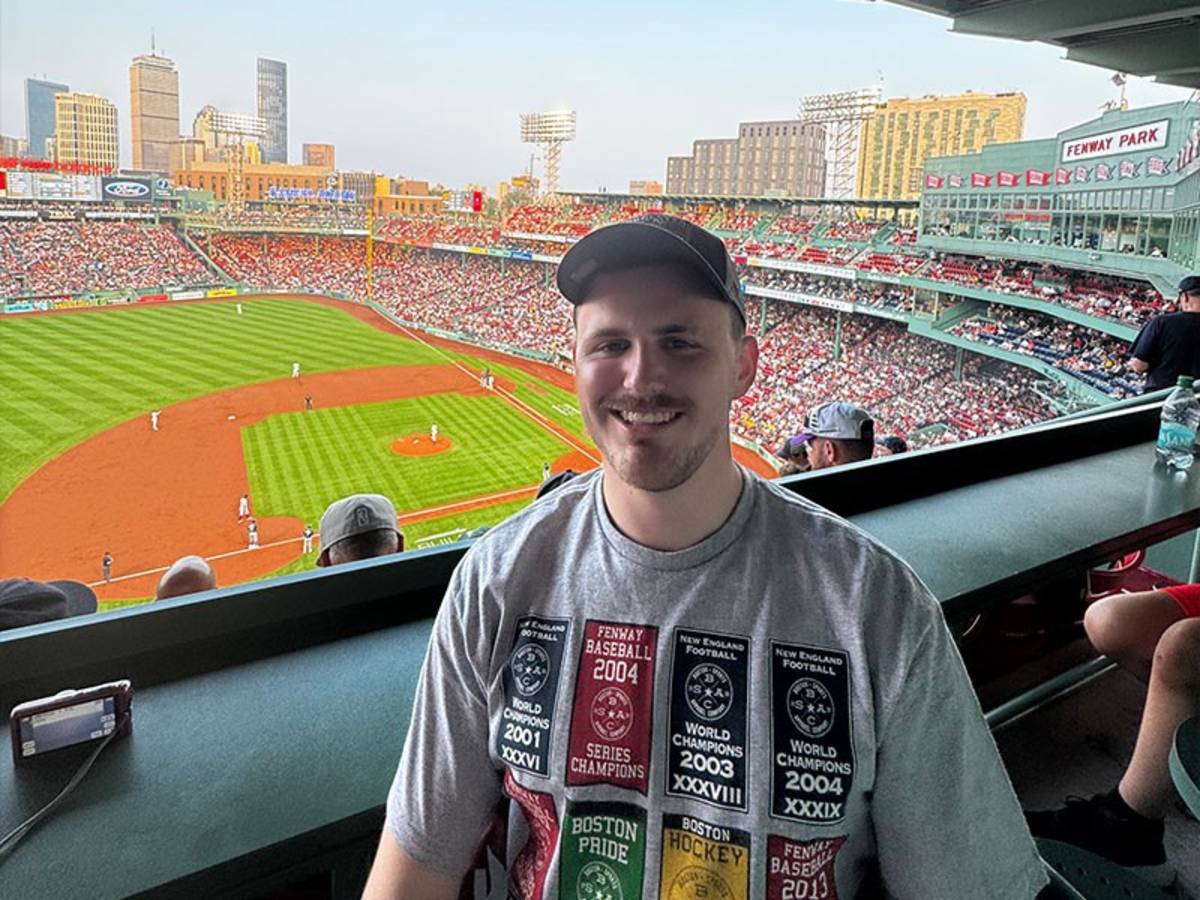 Man smiling at a baseball stadium