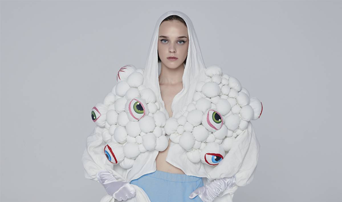 Model wearing white decorated hooded jacket