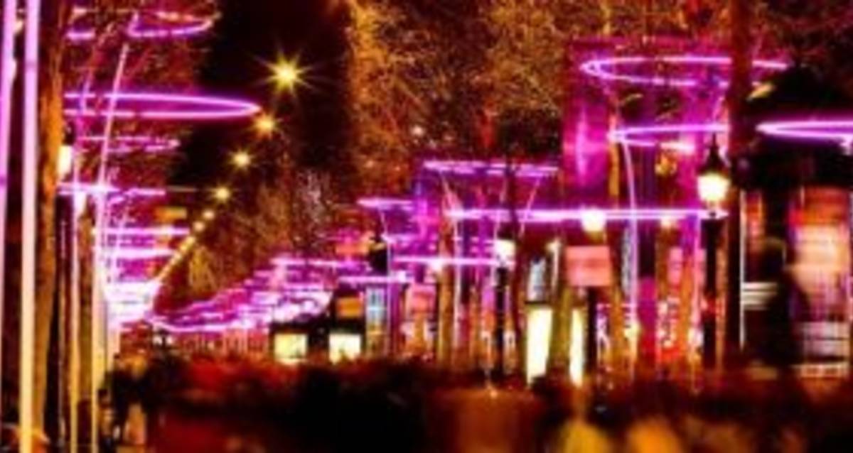 Nighttime cityscape with a pink glow from the lights