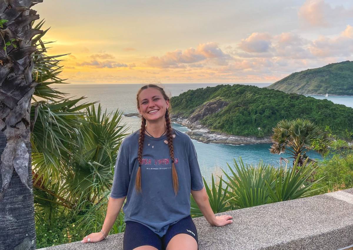 One of our interns pictured in front of a serene island view