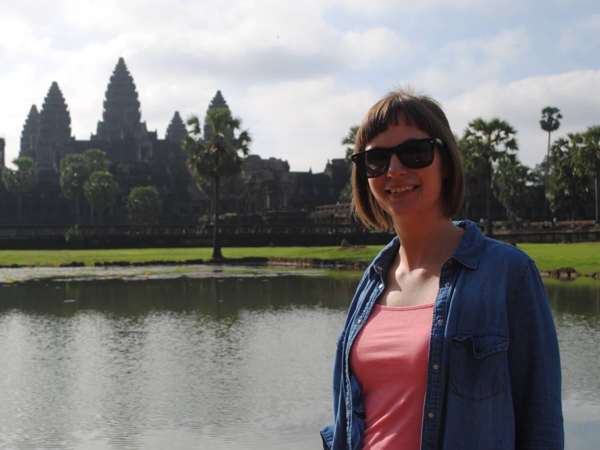 Our Director Rosie poses in front of a sacred temple