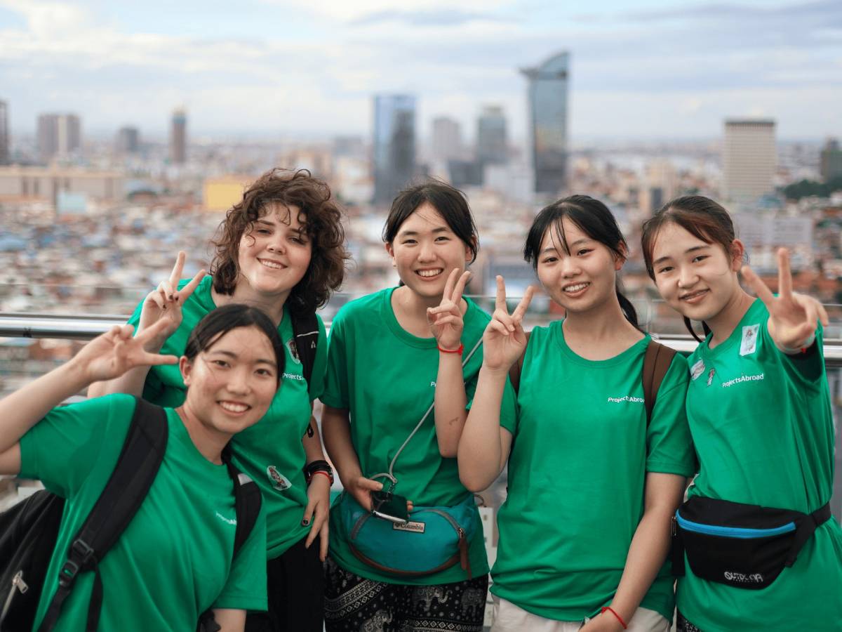 Participants smile for a picture overlooking Phnom Penh