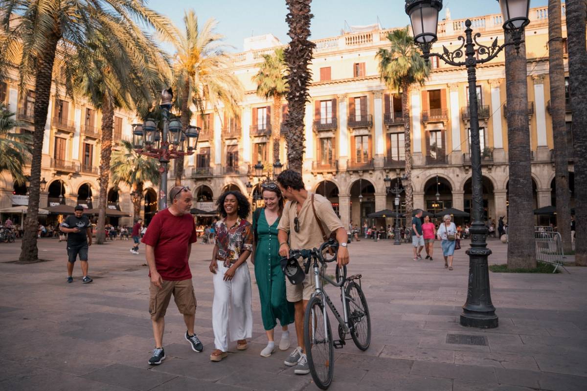 people in barcelona walking with bike