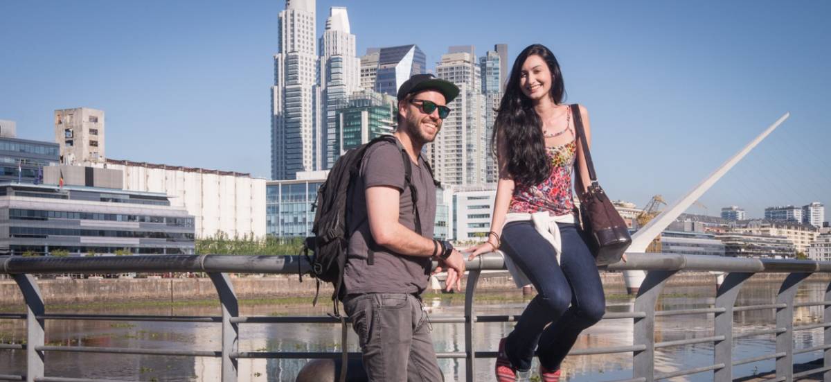 people on railing in the city