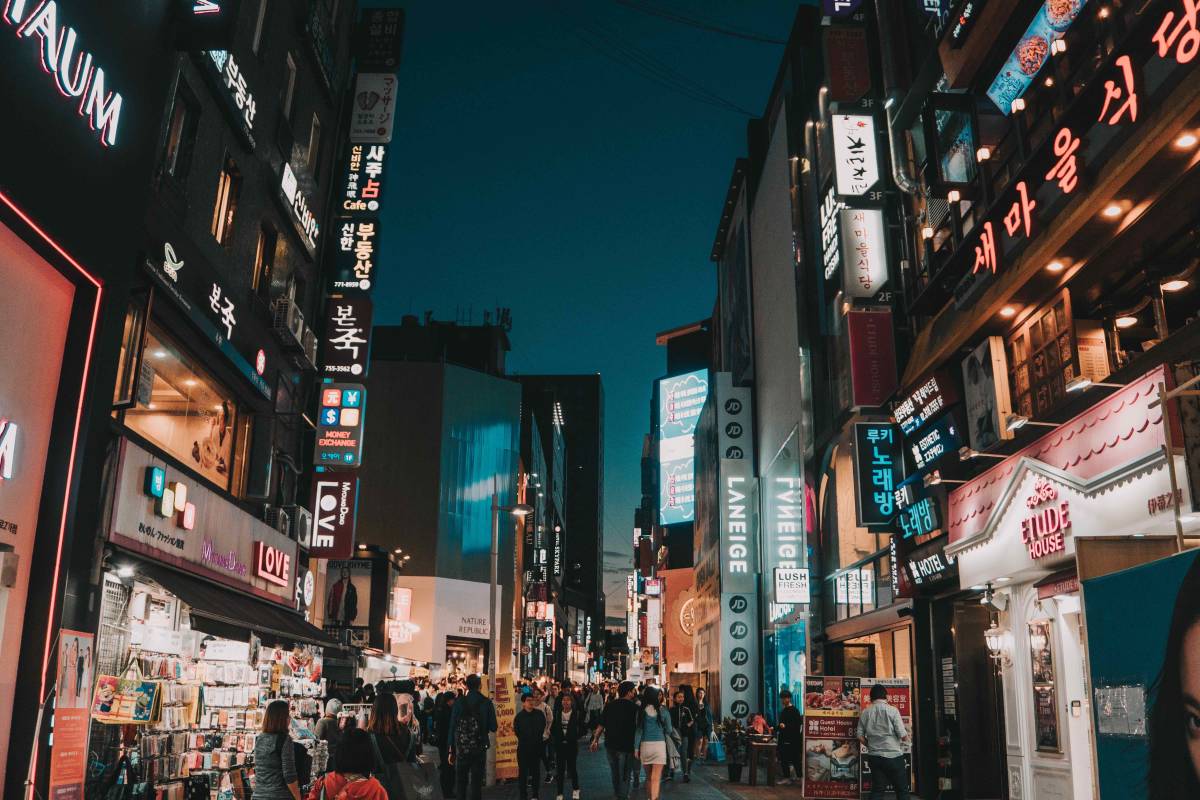 People walk in a crowded marketplace at night
