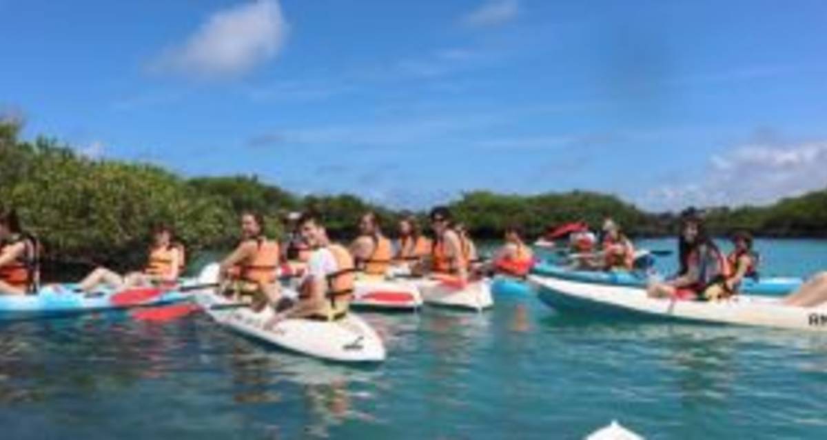 Person kayaking in turquoise waters of lagoon