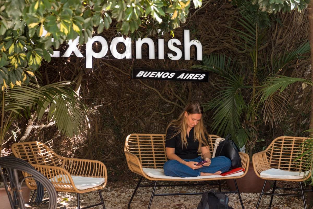 person sitting outdoor with expanish sign