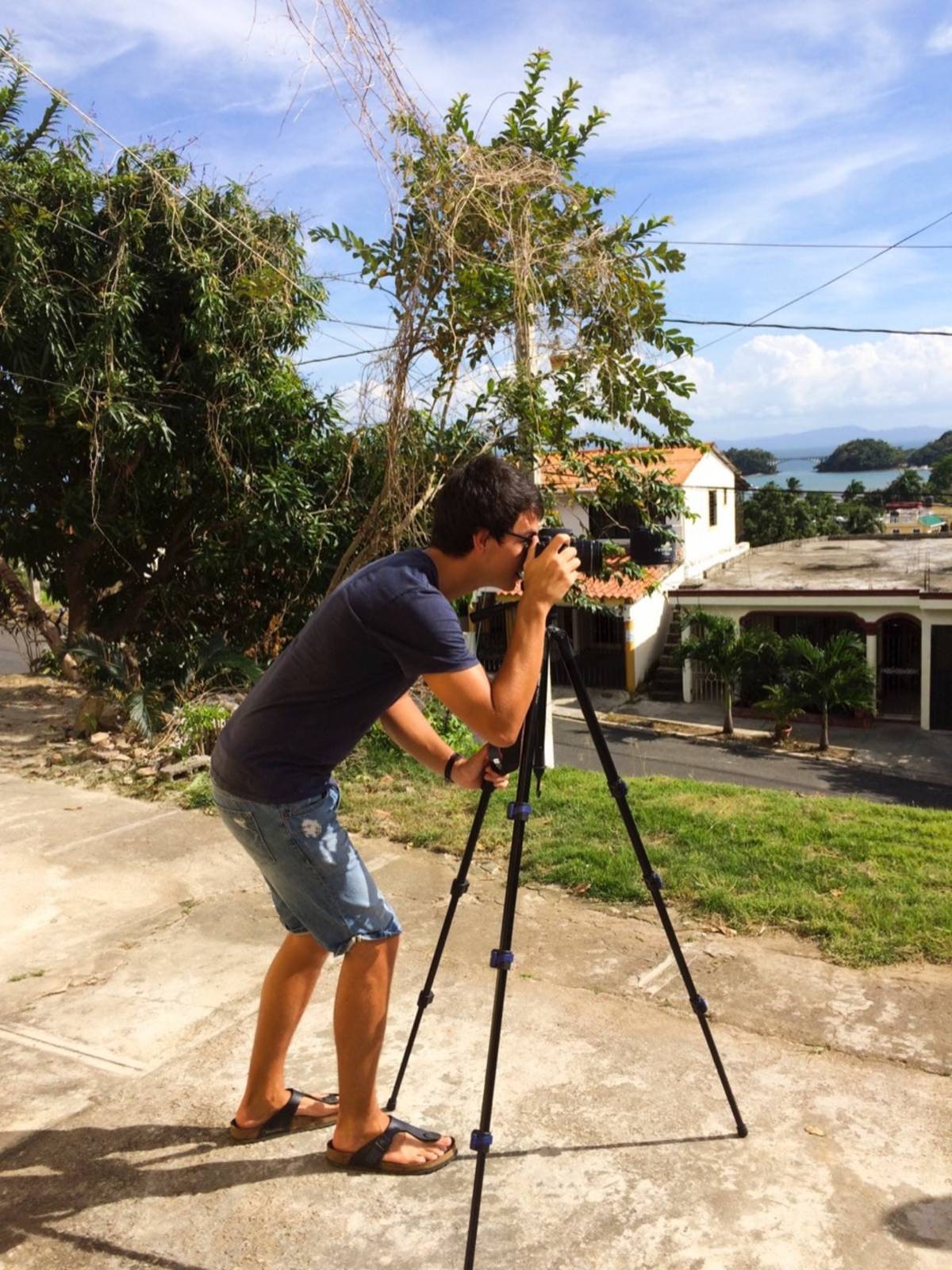person using a camera with tripod