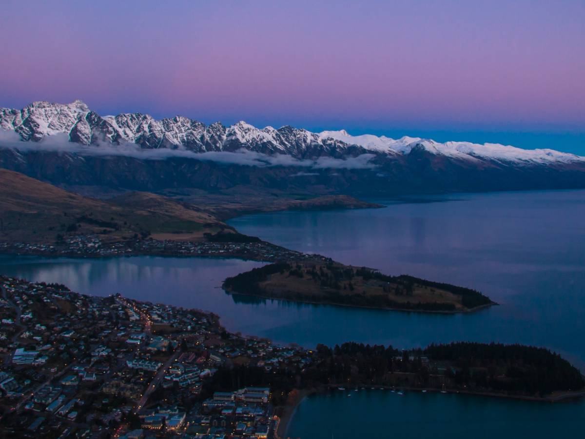 Queenstown skyline and mountains in New Zealand at sunset