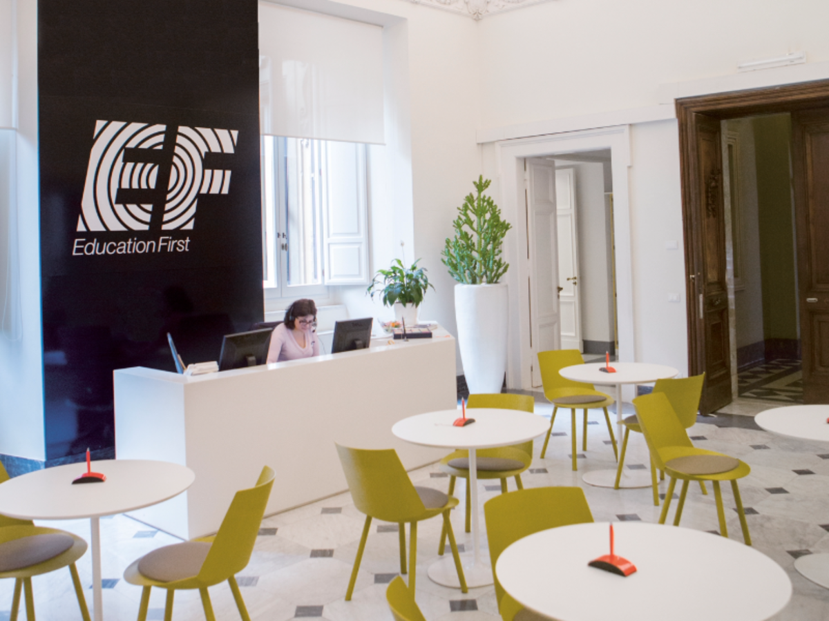 Reception area at EF Rome language school with modern seating, bright decor, and a welcoming front desk for students.