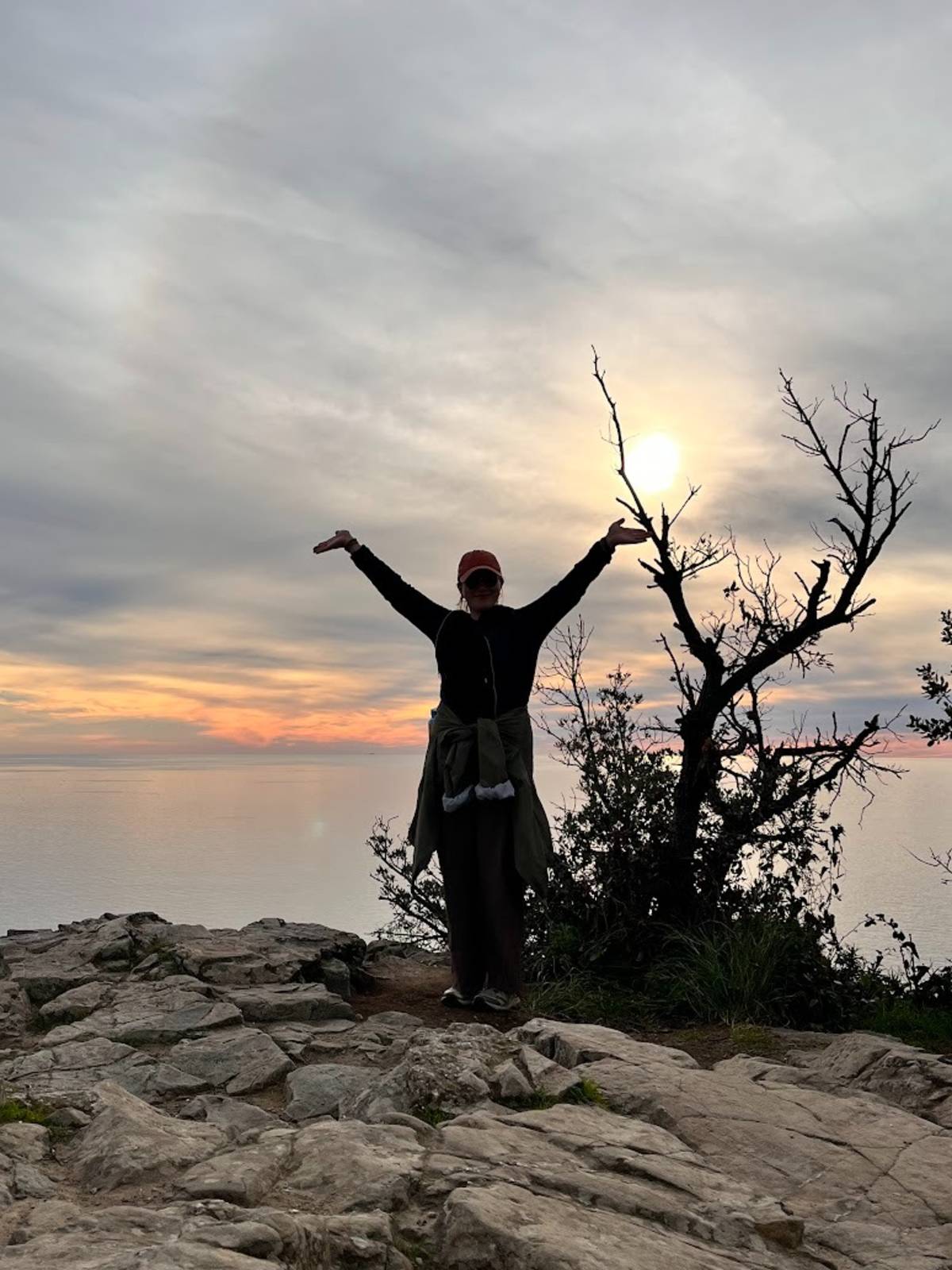 Siobhán enjoying a coastal sunset in Italy during her time teaching English abroad.