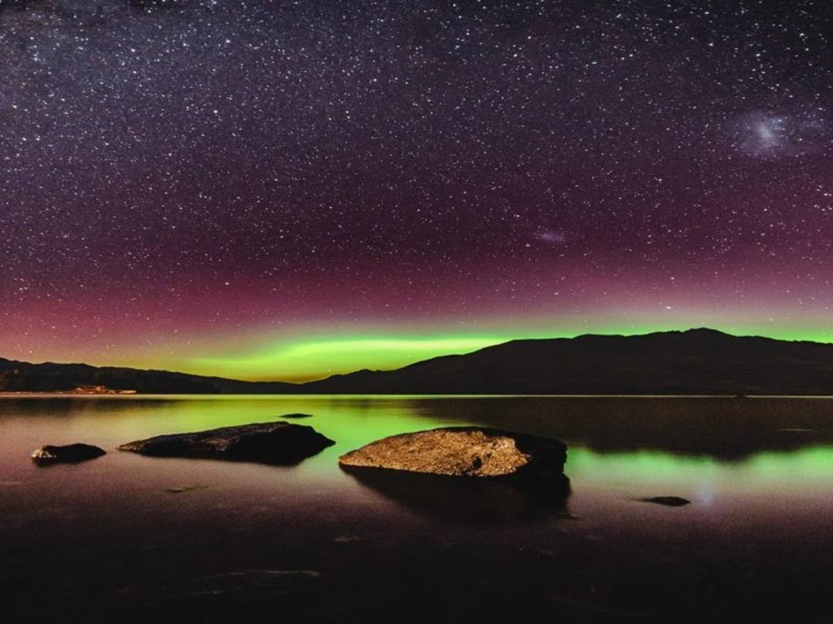 Southern lights over lake in New Zealand at night