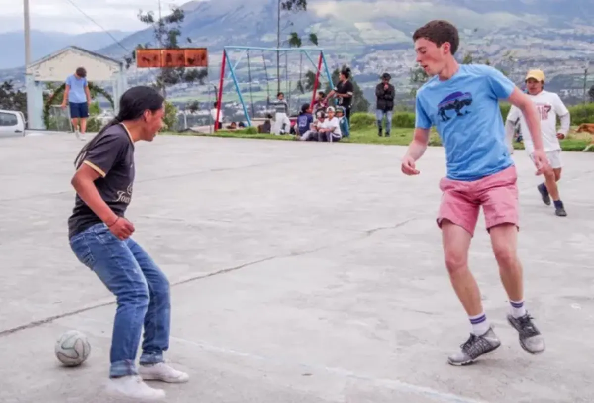 Student and local play soccer