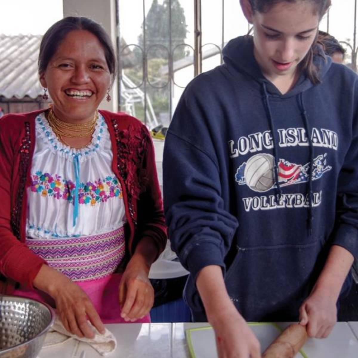 student cooking with woman in ecuador