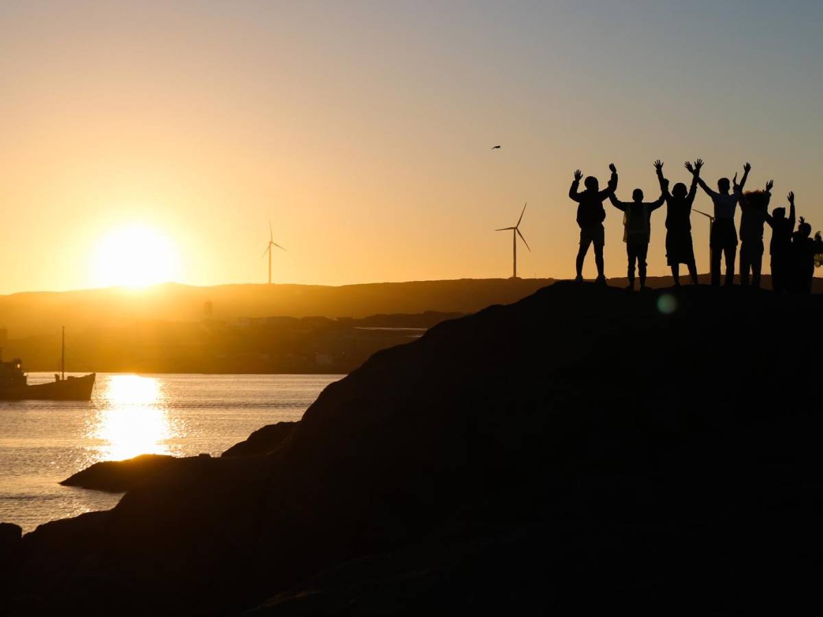 Student silhouettes at sunset over Lüderitz coastline