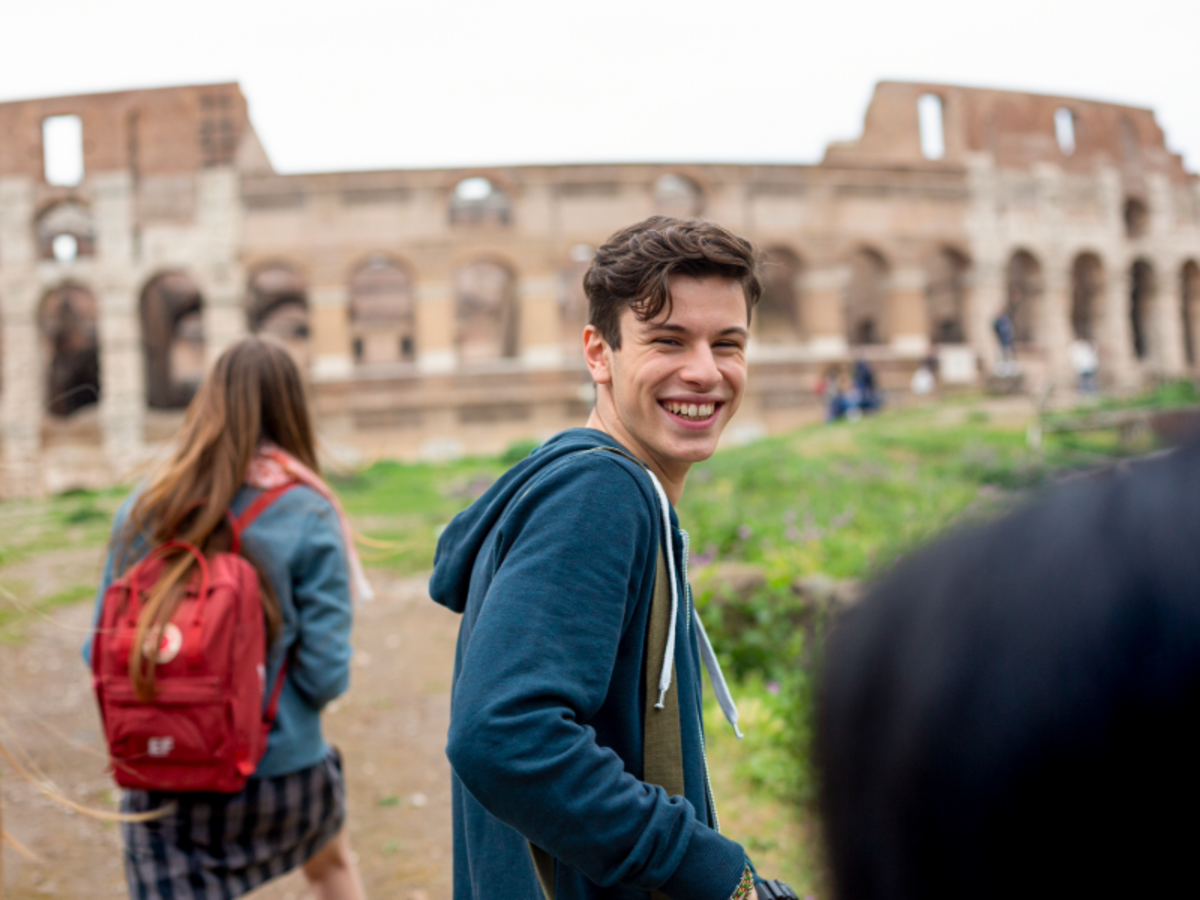 Student smiling while visiting the Colosseum in Rome during an EF Italian language program excursion.