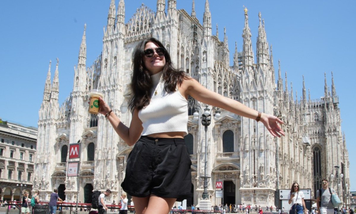 Student smiling with the Duomo di Milano in the background during a study abroad trip