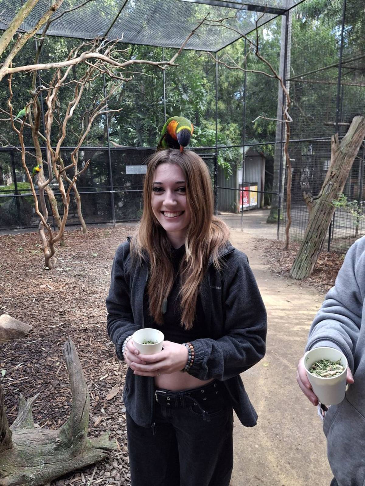 Student with parrot on her head