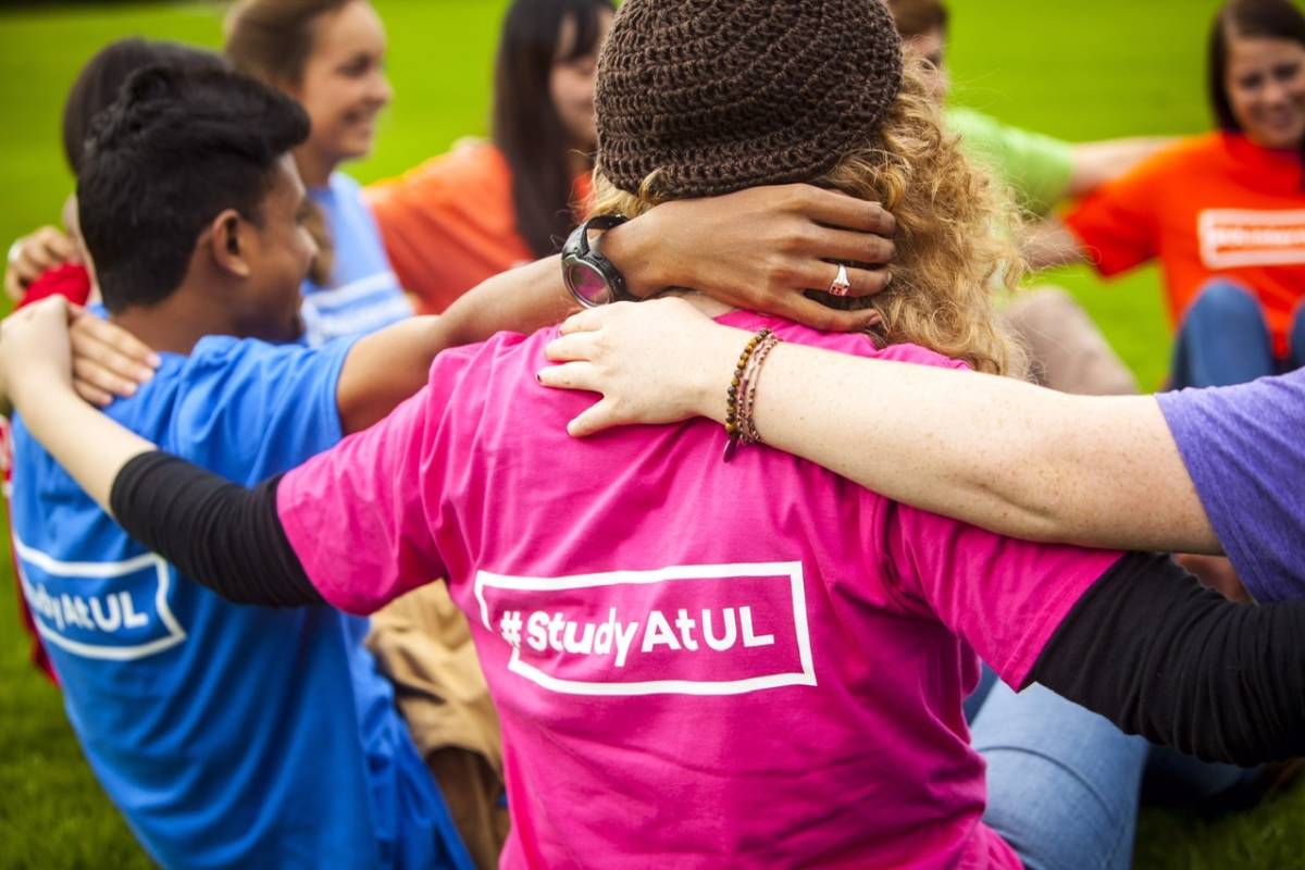 Students arms linked and T-Shirt reads  #study at UL 