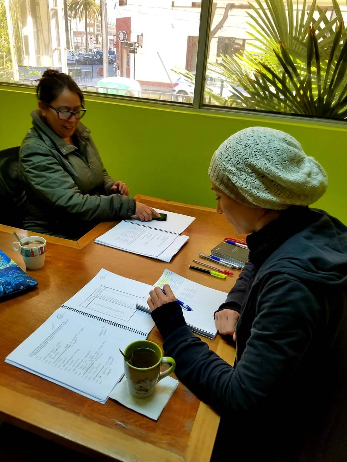 Students engaged in an English lesson inside a bright classroom in Chile, interacting with their teacher.