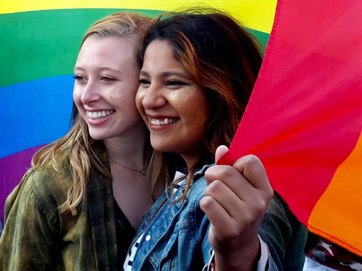 Students holding a Pride flag