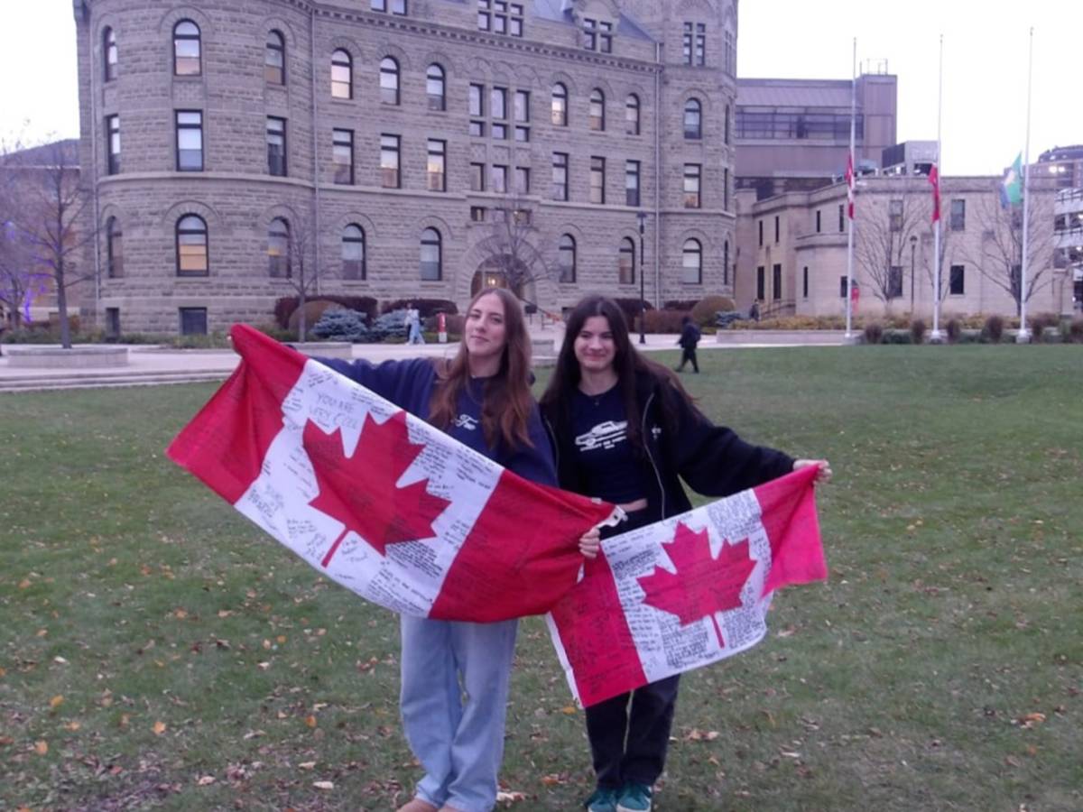 students holding Canadian flags 