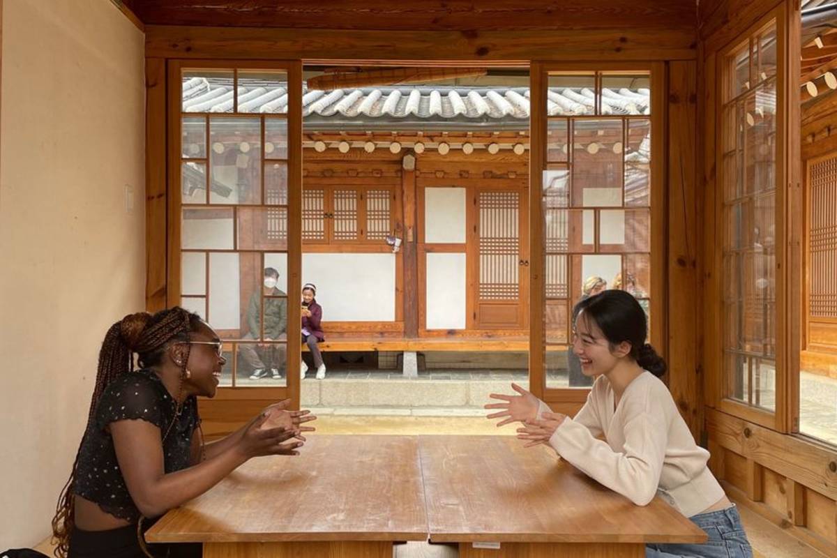 Students in Seoul chatting at table