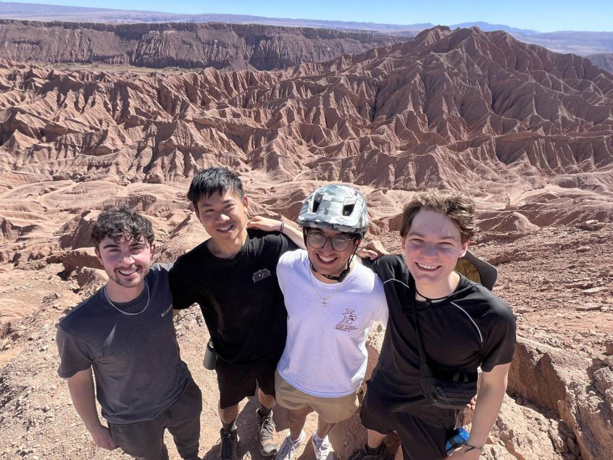students in the Atacama Desert with dry, orange mountains and valleys