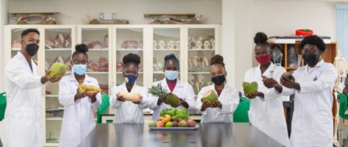 Students in the lab with fruits and vegetables indigenous to the C'bea