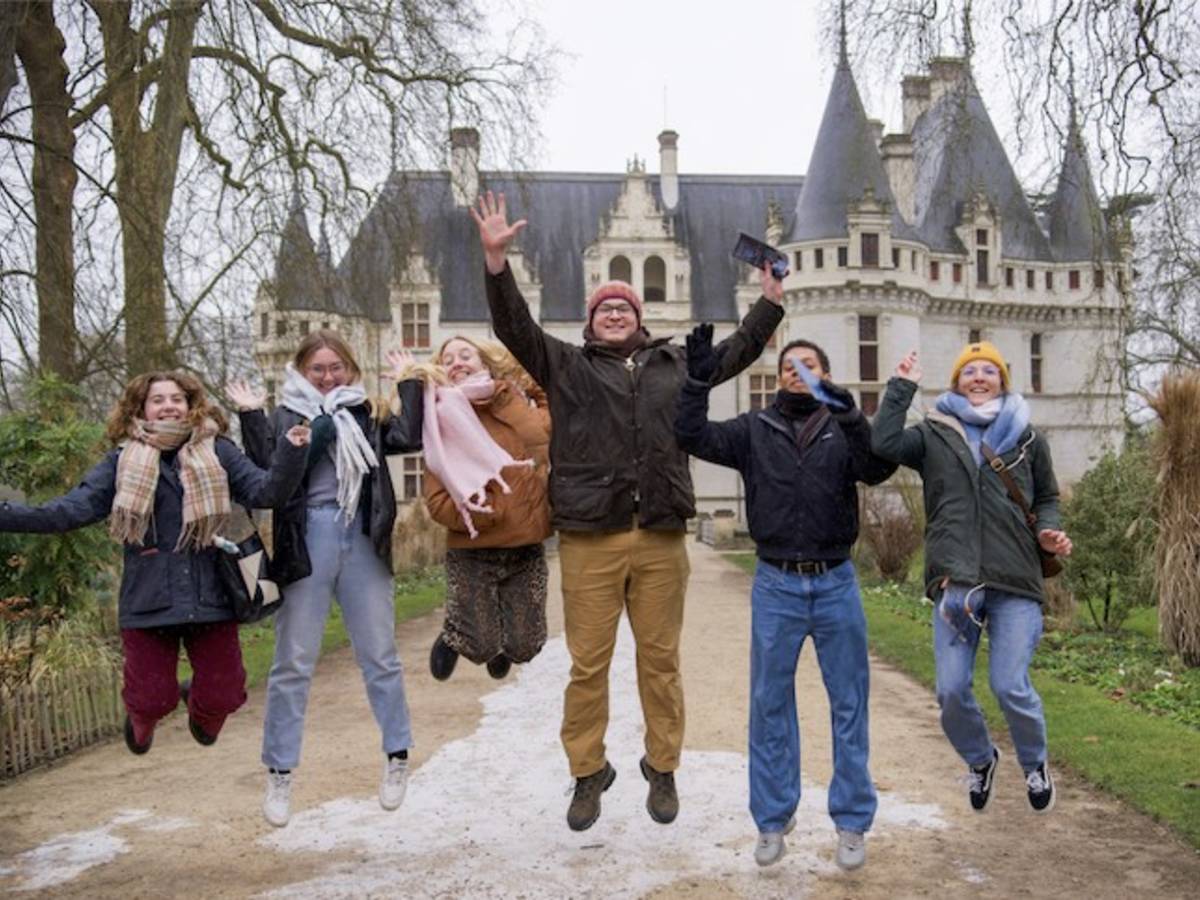 Students jumping in front of castle