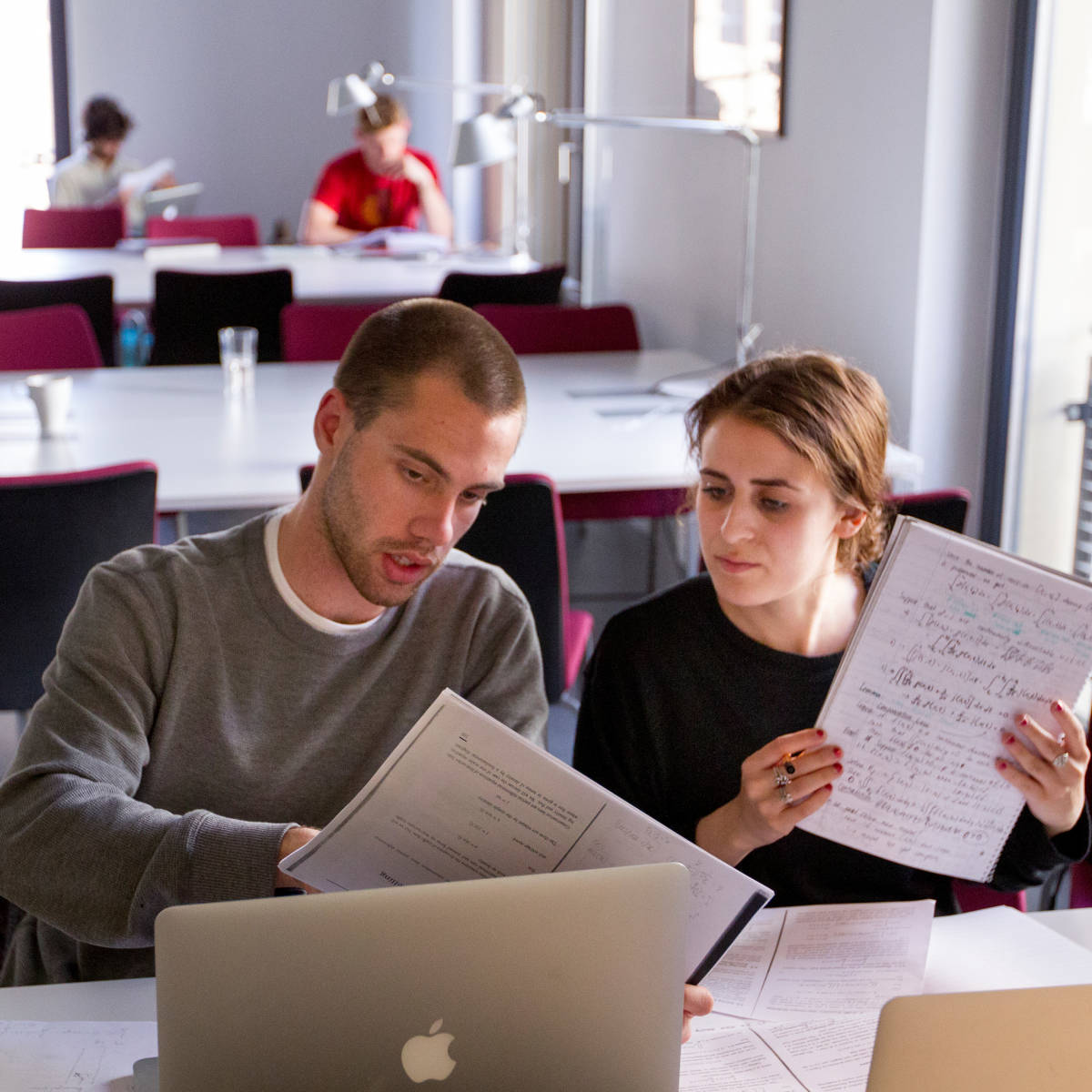 Students looking at a laptop.