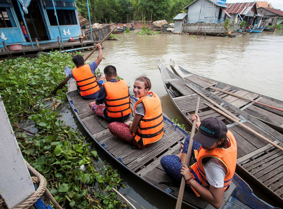 Students on a boat in Cambodia at the floating village
