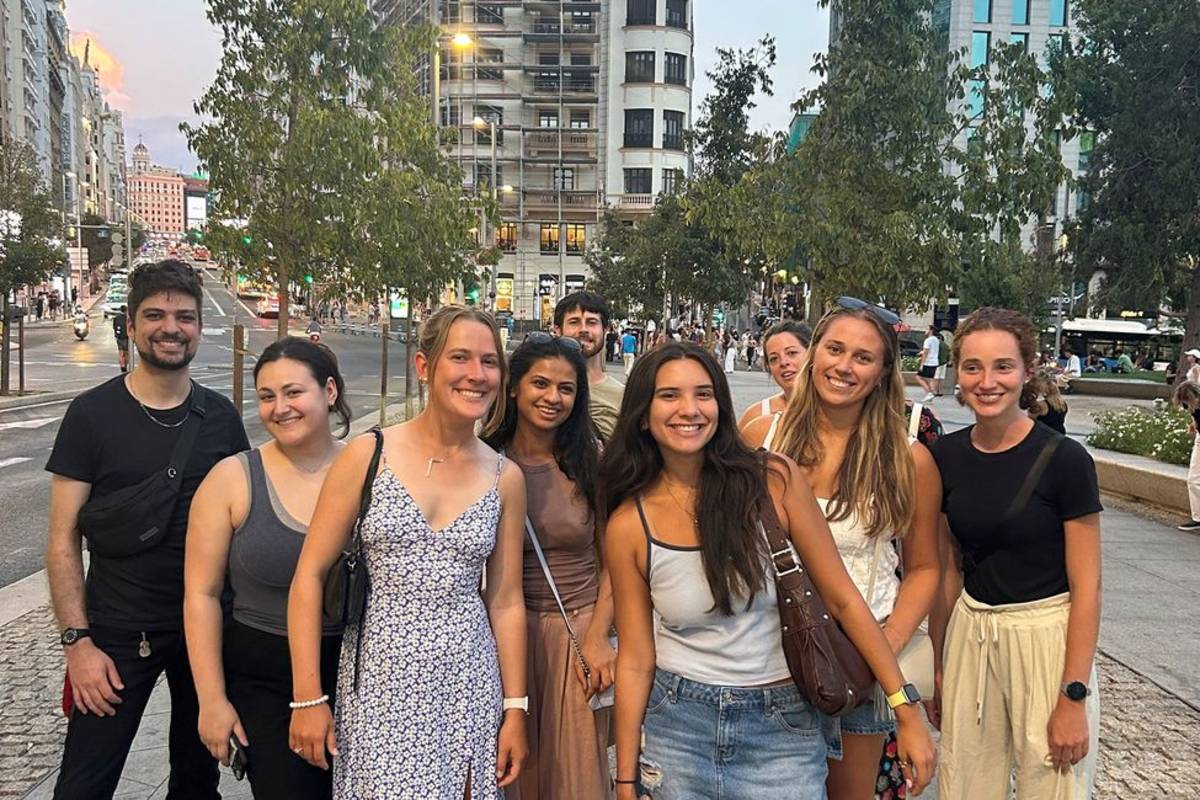 Students on street in Madrid smiling