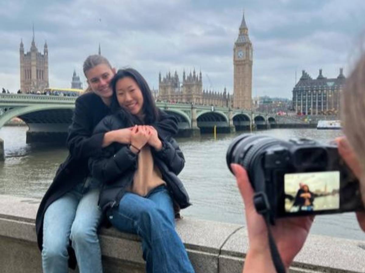Students pose for a photo along the River Thames with Big Ben in the background.