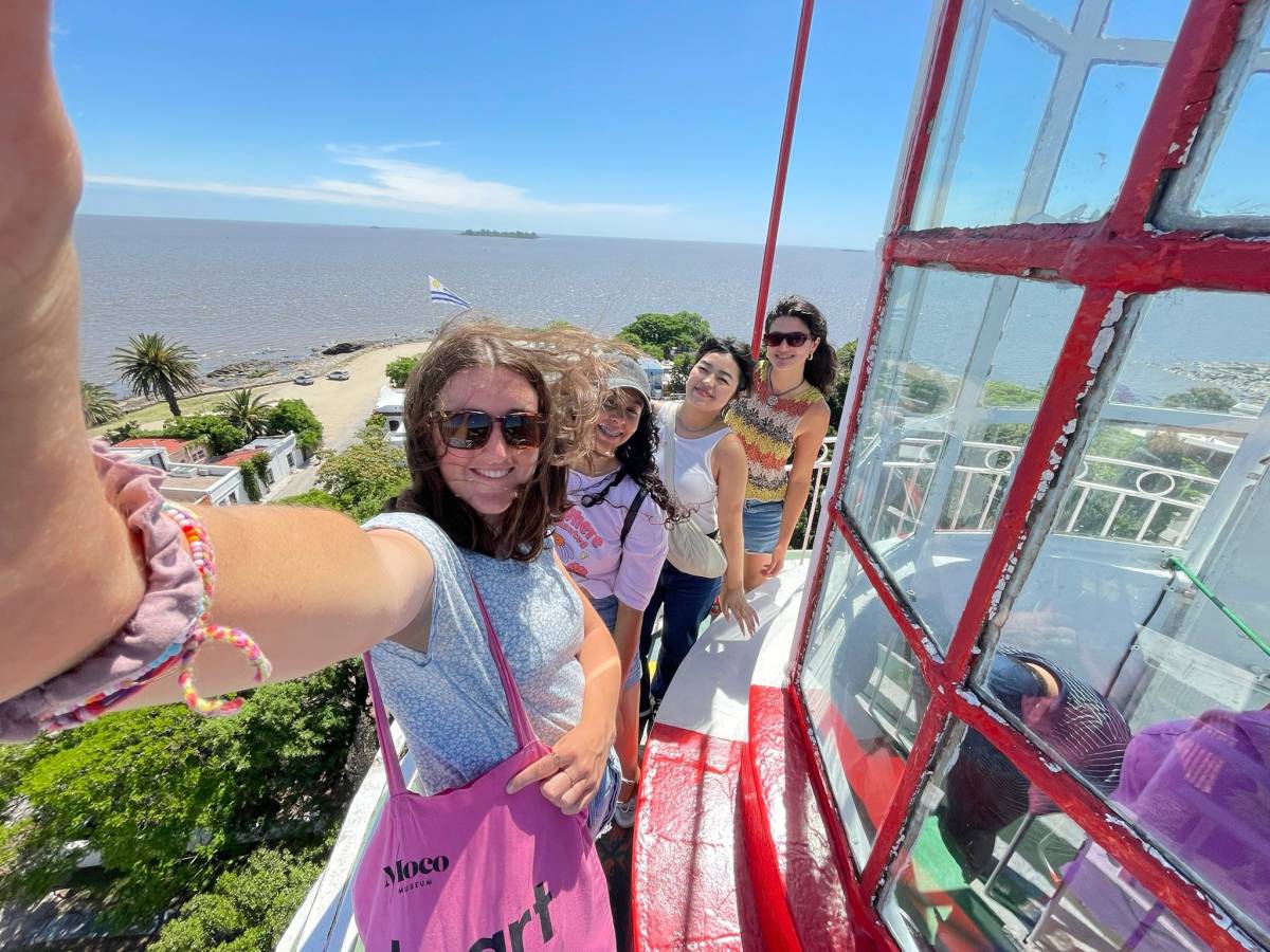 Students pose from atop a tall structure
