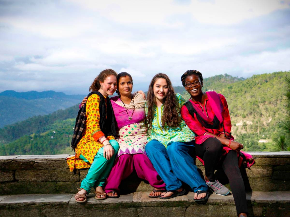 Students pose in India with mountains in background