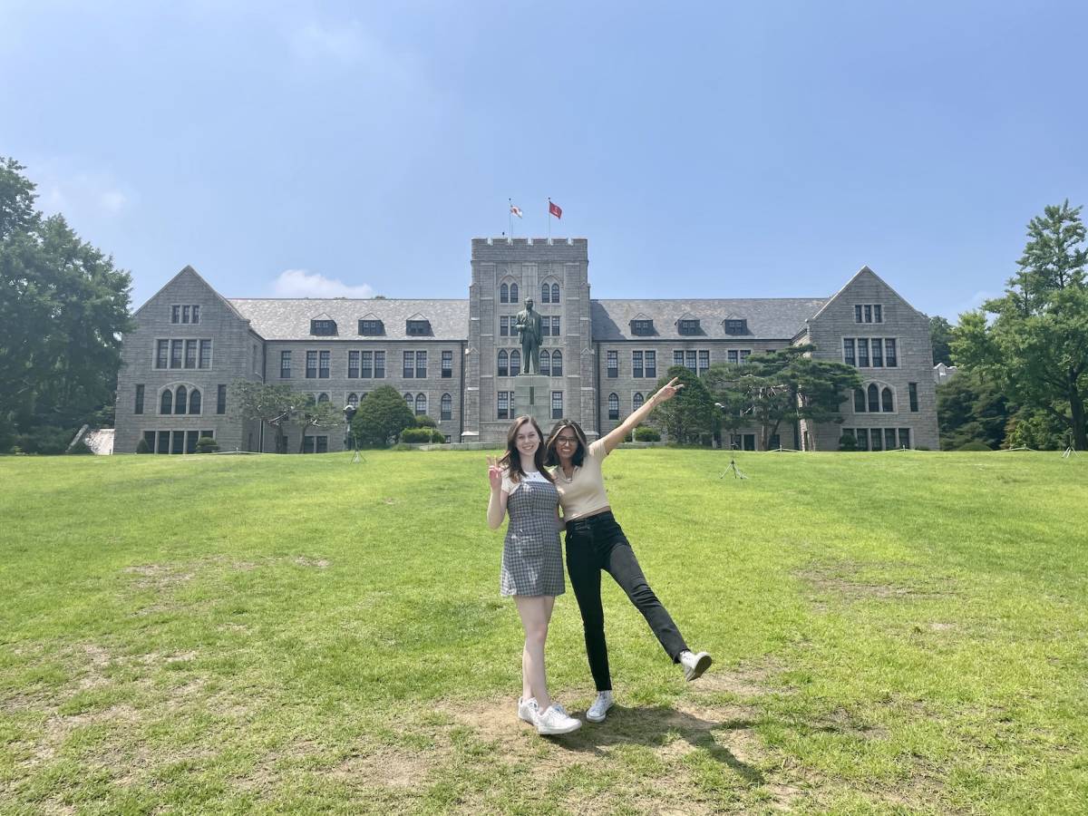 Students posing in front of building.