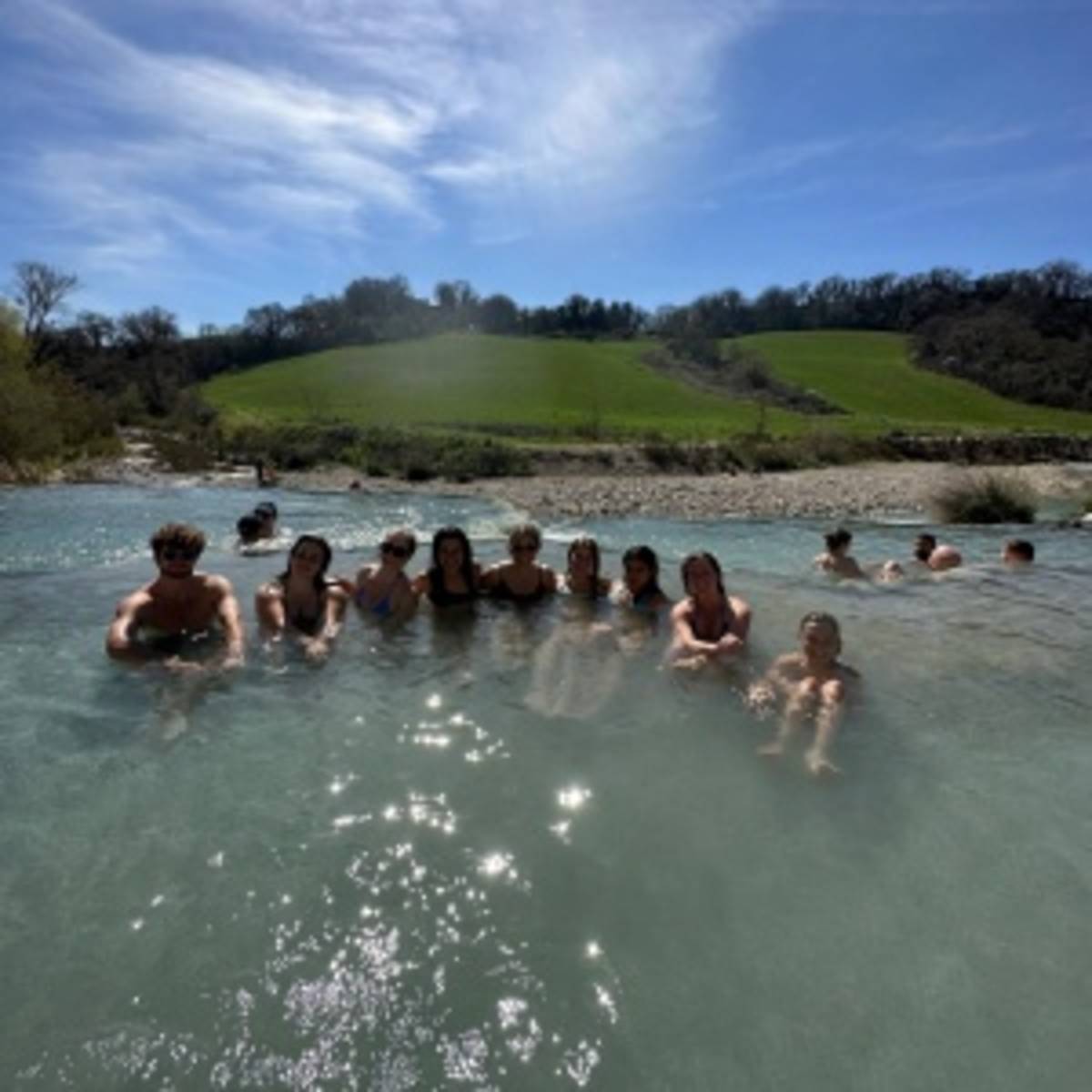 students posing in the water of Saturnia hotsprings