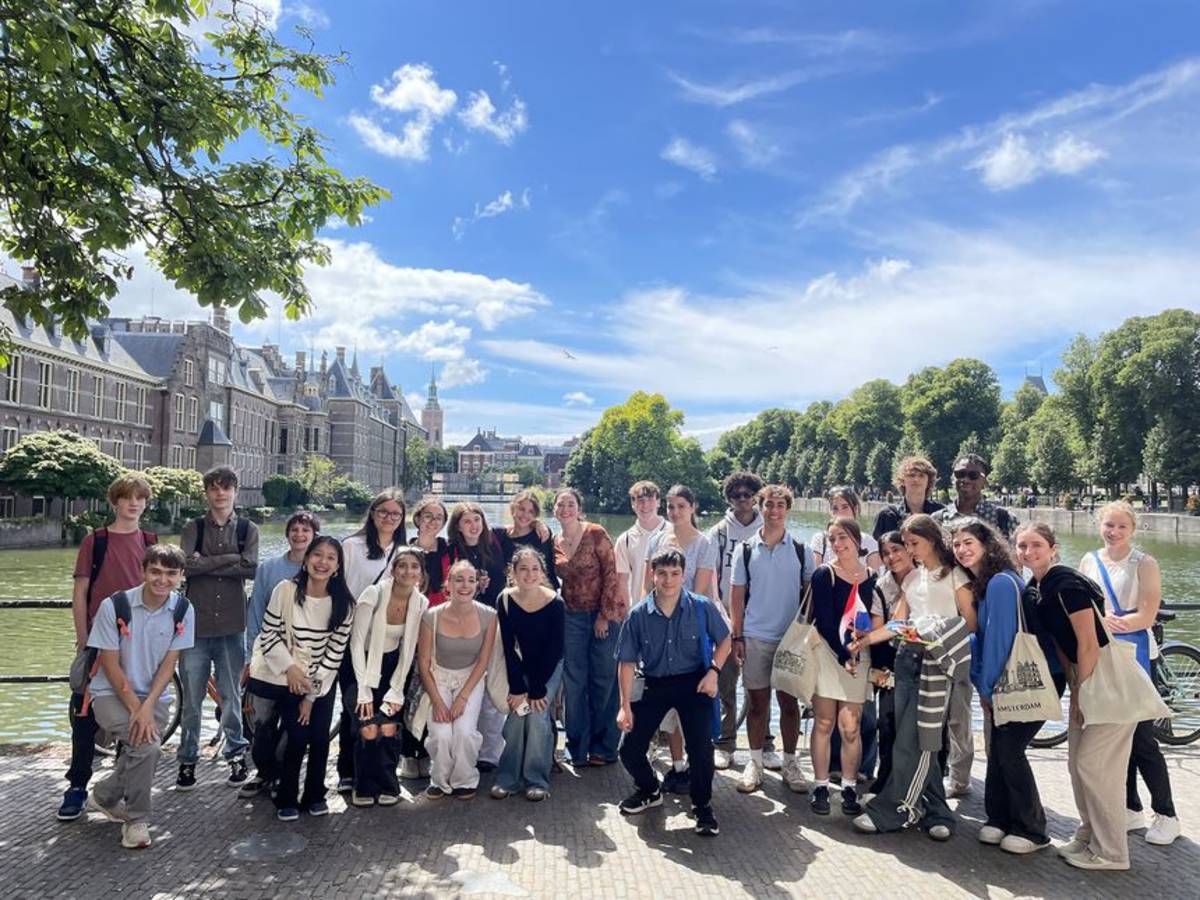 Students posing near the river in the Netherlands