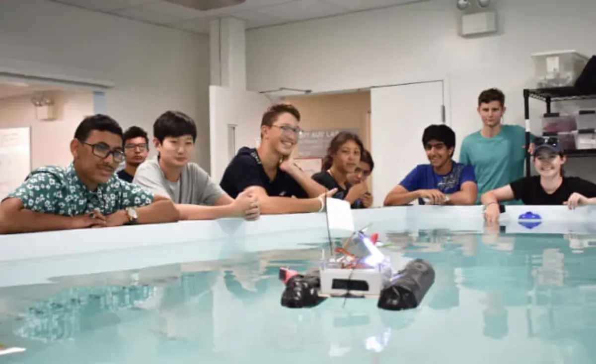 Students power a small device in the water